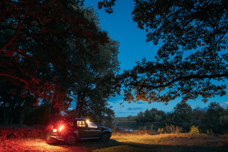 Car Renault Duster SUV in autumn night forest. Duster produced jのeditorial素材