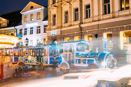 Tallinn, Estonia. Train For Sightseeing On Town Hall Square In Night Lighting