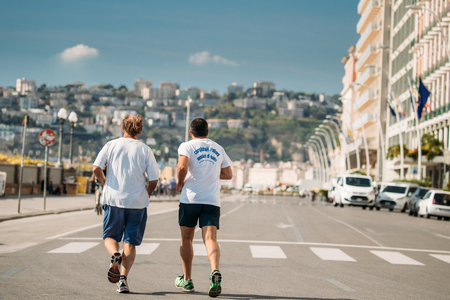 Naples, Italy. Two Adult Caucasian Men Running In Via Partenope Street In Sunny Day.のeditorial素材