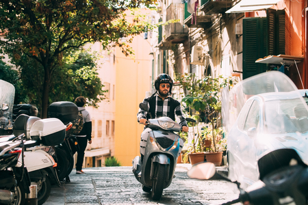 Naples, Italy. Man Riding On Scooter At Vico S. Nicola Da Tolentino Street.のeditorial素材