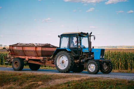 Malyye Avtyuki, Belarus - September 9, 2016: Tractor The MTZ-82 The Belarus On Country Road. Belarus - a Brand Of Universal Wheeled Tractor Wheels Produced By The Minsk Tractor Plant From 1974 To The Presentのeditorial素材