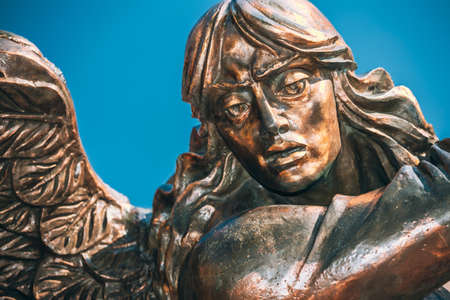 MINSK, BELARUS - MAY 4, 2015: Statue Of Archangel Michael With Outstretched Wings, Thrusting Spear Into Dragon near Red Catholic Church Of St. Simon And St. Helena On Independence Squareのeditorial素材