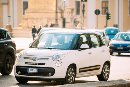 Rome, Italy - October 19, 2018: White Color Fiat 500L Moving At Rome Street. Five-door, five...