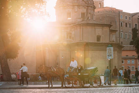 Rome, Italy - October 19, 2018: Horses In Old-fashioned Coach Carriage Near Santi Luca E Martina Church And Senatorial Palace. Sunlight During Sunset Sunrise. UNESCO World Heritage Site.のeditorial素材