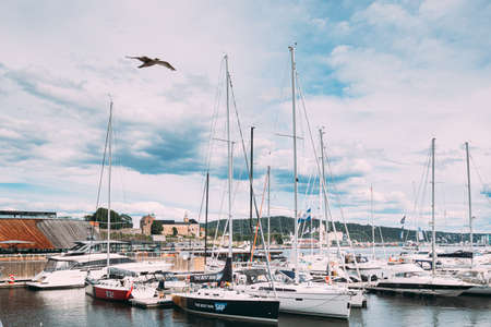 Oslo, Norway - June 24, 2019: Moored Boats And Yachts At Aker Brygge District. Seascape Of Harbour And Quays In Summer Day Under Scenic Cloudy Sky.のeditorial素材