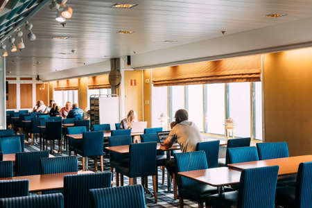 Riga, Latvia - June 10, 2019: People Are Sitting At Tables In A Cafe On A Ferry Boat.のeditorial素材