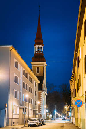 Parnu, Estonia - December 14, 2017: Night View Of Nikolai Street With Old Houses, Restaurants, Cafe, Hotels And Shops In Evening Night Illuminations. View Of Lutheran Church Of St. Elizabeth On Backgroundのeditorial素材