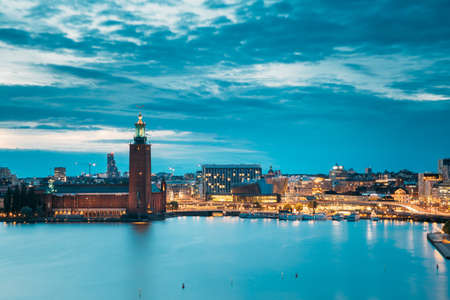 Stockholm, Sweden - June 28, 2019: Scenic Skyline View Of Famous Tower Of Stockholm City Hall. Building Of Municipal Council. Famous Popular Destination Place In Dusk Lights. Night Lighting.のeditorial素材