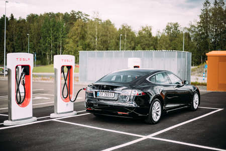 Black Color Tesla Model S 100d Car Parked At Charging Station. The Tesla Model S Is A Full-sized All-electric Five-door, Luxury Liftback, Produced By Tesla Inc.のeditorial素材