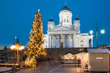 Helsinki, Finland. Christmas Xmas Holiday Carousel On Senate Square Near Famous Landmark. Lutheran Cathedral At Winter Eveningのeditorial素材