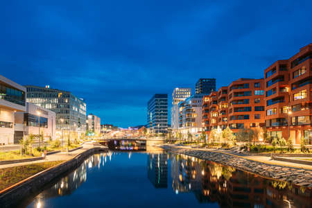Oslo, Norway. Night View Embankment And Residential Multi-storey House In Gamle Oslo District. Summer Evening. Residential Area Reflected In Sea Waters.のeditorial素材