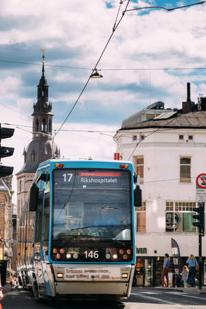 Oslo, Norway - June 24, 2019: Blue Public Tram In Summer Street.のeditorial素材