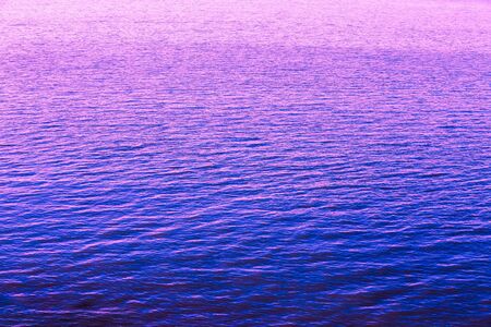 Calm Sea Ocean RiverRipple Surface Natural Blue Background. Toned Photo In Ultra Violet Color.の写真素材