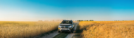 Renault Duster or Dacia Duster SUV in summer wheat field country