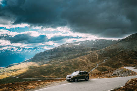 Aurlandsfjellet, Norway. Car Renault Duster SUV Parked Near Aurlandsfjellet Scenic Route Road In Summer Norwegian Landscape. Natural Norwegian Landmark And Popular Destination.のeditorial素材