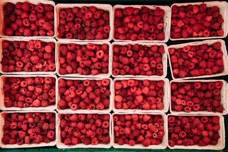 Fresh Red Berries Raspberries At Market In Trays, Containers. Top View Of Ripe Berries. Autumn...