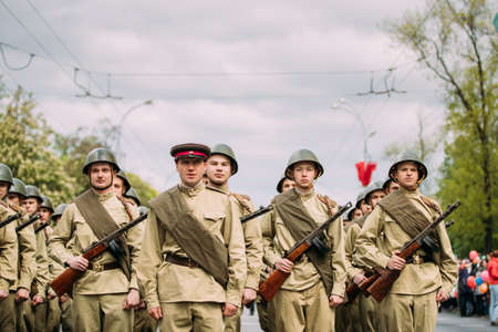 Gomel, Belarus. Re-enactos Dressed As Russian Soviet Soldiers Of World War Taking Part In Parade During Celebration Of Victory Day 9 Mayのeditorial素材