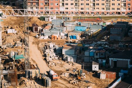 Minsk, Belarus. Special Concrete Transport Truck (In-Transit Mixer) Unit On City Building Site. Construction Of Housesの写真素材