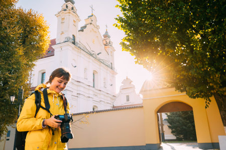 Pinsk, Brest Region, Belarus. Young Woman Tourist Lady Photograph Taking Pictures Near Cathedral Of...