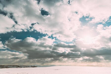 Winter Meadow Field At Cloudy Day. Sunset. Countryside Snowy Rural Landscape. Agricultural Landscape In February.の写真素材