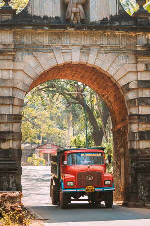 Old Goa, India - February 19, 2020: Red Truck Moving Through The Old Viceroy s Arch. Famous Vasco Da...