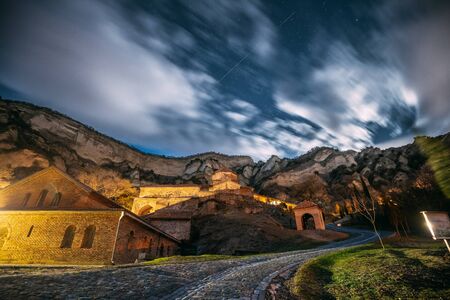 Mtskheta, Georgia. Medieval Monastic Shio-Mgvime Monastery Shiomgvime Complex Under Autumn Night Starry Sky With Glowing Stars And Real Meteoric Track Trail Over Above Famous Place.の写真素材