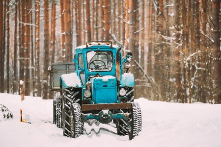 Tractor On Country Forest Road In Winter Snowy Day.の写真素材