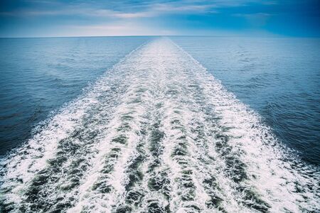 Sea. Water Ocean Waves Trails From Floating Ship Or Ferry Boat. Top View.の写真素材