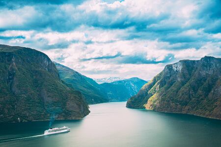 Sogn And Fjordane Fjord, Norway. Tourist Ship Ferry Boat Liner Floating In Amazing Fjord Sogn Og Fjordane. Summer Scenic View Of Famous Natural Attraction Landmark And Popular Destination In Summerの写真素材