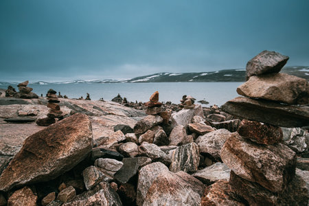Norway. Stones On Coast Of Beautiful Lake Orteren In Spring Cloudy Day. Norwegian Nature.