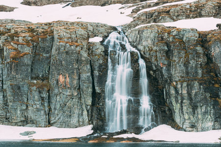 Road Aurlandsfjellet, Norway. Waterfall Flotvatnet In Spring Snowy Landscape. Scenic Route Road In...
