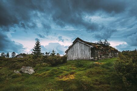 Traditional Norwegian Old Wooden Houses With Growing Grass On Roof. Cabins In Norway.の写真素材