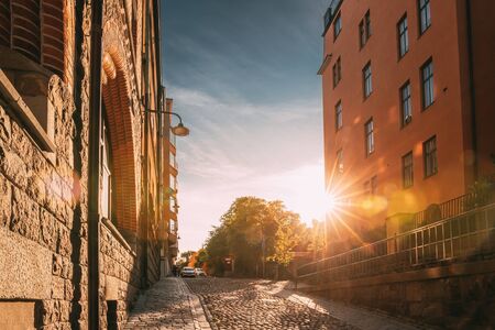 Stockholm, Sweden. Sunshine During Sunset Above Stockholm Street. Beautiful Street With Multi-storey House In Sunny Summer Evening. Cozy Side Street.の写真素材