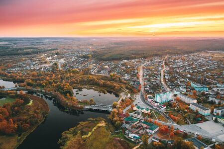 Dobrush, Gomel Region, Belarus. Aerial View Of Dobrush Cityscape Skyline In Autumn Evening. Residential District And River During Sunset. Birds-eye Viewの写真素材