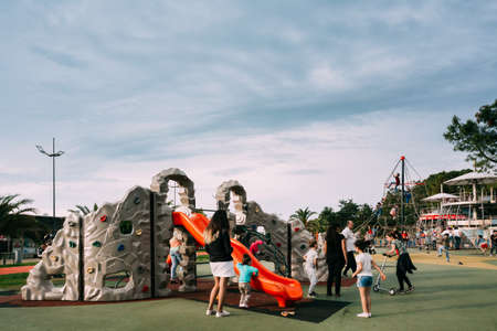 Batumi, Adjara, Georgia - May 26, 2016: Children and adults play on playground on city street near waterfront.のeditorial素材