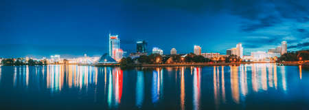 Minsk, Belarus - September 3, 2016: Panorama With Residential House Near Pobediteley Avenue And Svisloch River. Summer Evening, Night Lights Illumination Reflected in Water. Panorama Panoramic View.のeditorial素材