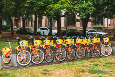 Vilnius, Lithuania - July 5, 2016: Row Of Colorful Bicycles AVIVA For Rent At Municipal Bike Parking In Street. Summer Day After Rainのeditorial素材