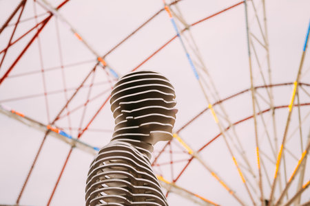 Batumi, Adjara, Georgia - May 22, 2016: A moving metal sculpture on ferris wheel background....