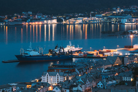 Alesund, Norway - June 21, 2019: Moored Ship In Port. Night View Of Alesund Skyline Cityscape. Summer Evening.のeditorial素材