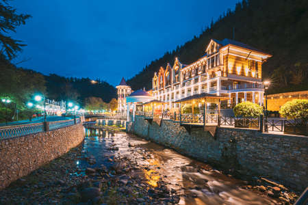 Borjomi, Georgia - October 24, 2016: Crowne Plaza Borjomi Hotel House And Pedestrian Bridge Over River Borjomula At Autumn October Evening In Night Illuminations Lights.のeditorial素材