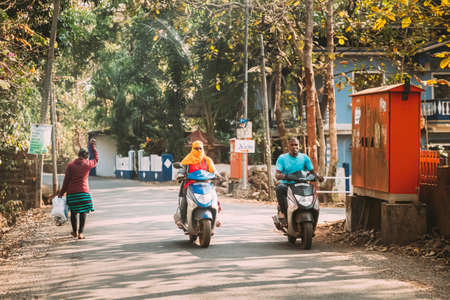 Goa, India - February 14, 2020: People Riding On Scooters Motorcycle On Street.のeditorial素材