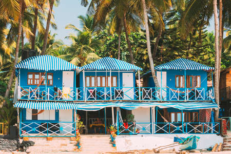 Canacona, Goa, India - February 16, 2020: Famous Painted Guest Houses On Palolem Beach Against Background Of Tall Palm Trees In Sunny Day.のeditorial素材