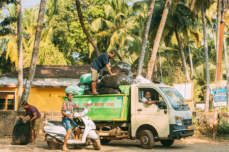 Patnem, Goa, India - February 16, 2020: Men Workers Pack Garbage And Load It On Truck.のeditorial素材