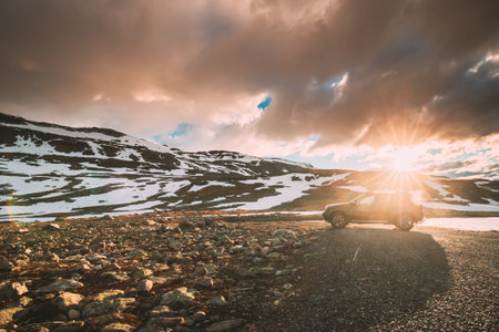 Aurlandsfjellet, Norway - June 13, 2019: Car Renault Duster SUV Parked Near Aurlandsfjellet Scenic Route Road In Summer Norwegian Landscape. Popular Destination In Sunset Lights.のeditorial素材