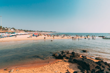 Mapusa, Anjuna, Goa, India - February 19, 2020: People Visit And Relax On Baga Beach At Sunny...
