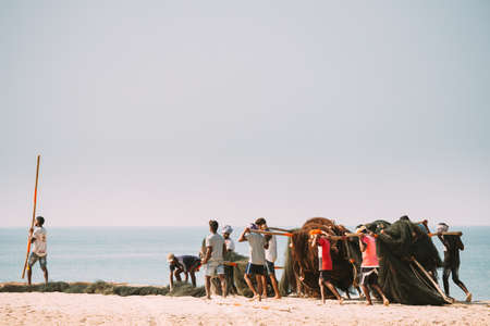 Arossim, Goa, India - February 18, 2020: Fishermen Lay Out Nets To Twist Themのeditorial素材