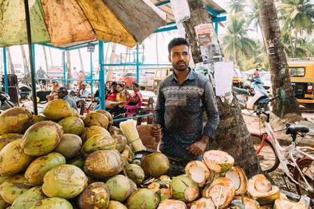 Canacona, Goa, India - February 16, 2020: Coconut Seller In Grocery Market