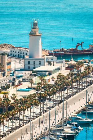 Malaga, Spain. Lighthouse and marina in sunny summer day.の写真素材