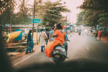 Goa, India - February 13, 2020: People Riding On Scooter Motorcycle On Street.のeditorial素材