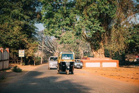 ponda, Goa, India - February 20, 2020: Auto Rickshaw Or Tuk-tuk Moving On Street In Sunny Day.